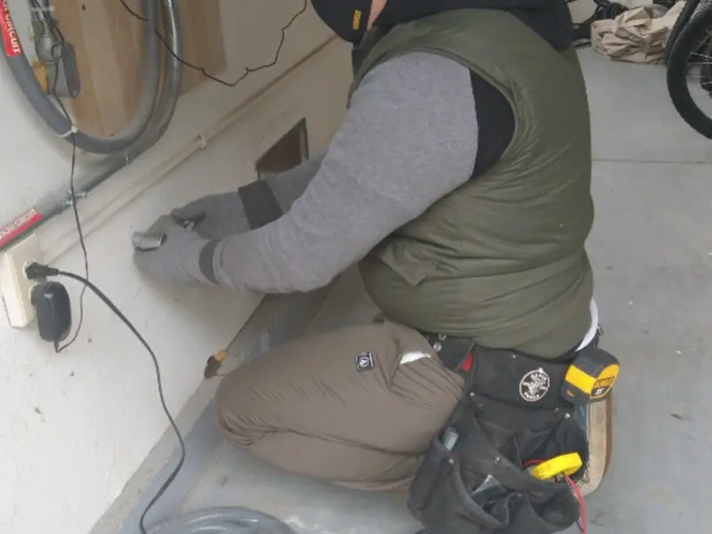 Electrician performing outlet wiring in a South Middleton garage